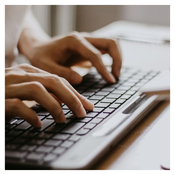 person typing on keyboard